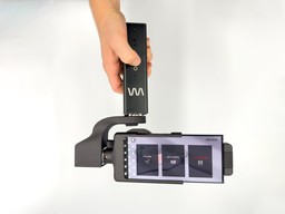 Gimbal with a phone attached, showing the main screen of a photo-taking app.